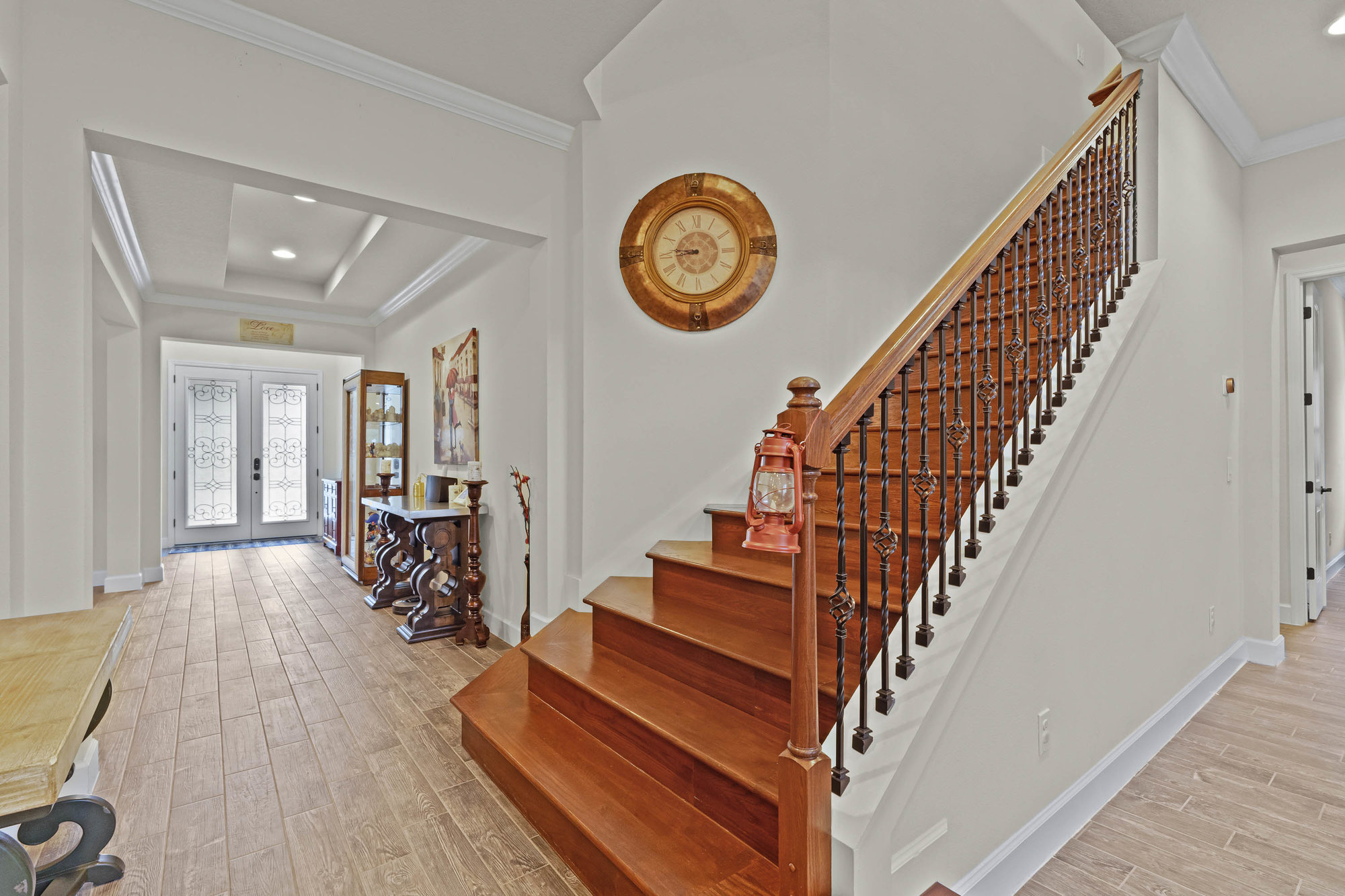 entryway with double glass frosted doors and wooden staircase